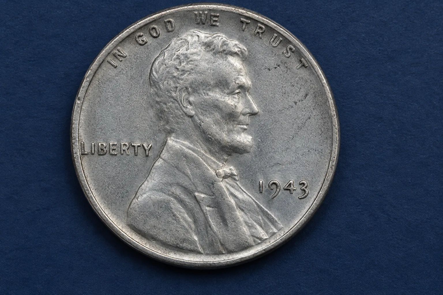 Close-up editorial illustration of the 1943 date and mint-mark area on a steel cent