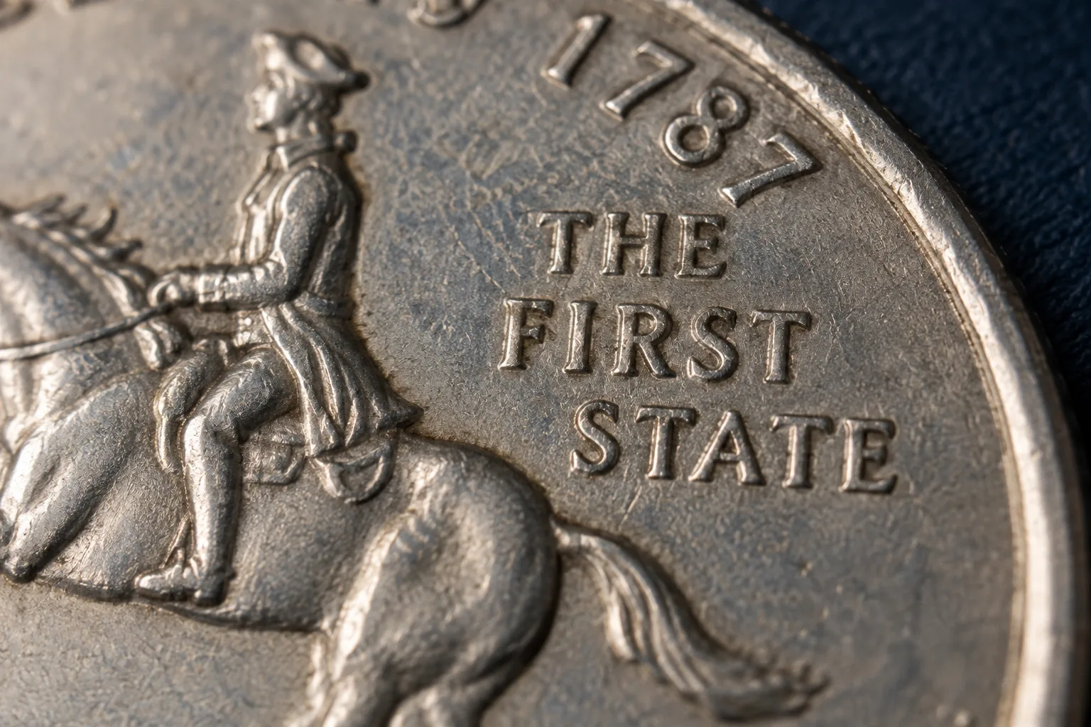 The First State inscription on the Delaware Quarter reverse